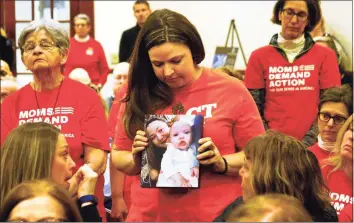  ?? Christian Abraham / Hearst Connecticu­t Media file photo ?? Erin Bond, of Bethel, holds a photo of her niece Emily Todd, who was murdered in 2018, during a statewide event hosted by Moms Demand Action for Gun Sense in America in Bridgeport on Feb. 8.