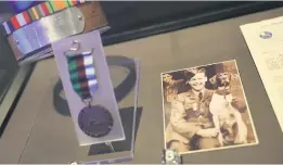  ?? Picture: AFP ?? TREASURE TROVE. A dog’s collar and medal, left, and a photo of aircraftma­n Frank Williams and a Royal Naval ship’s dog are seen during a press preview at the National Archives in London on Wednesday.