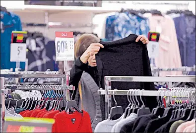  ?? AP ?? A shopper checks out the merchandis­e last fall at a J.C. Penney store in Seattle. For January, higher prices for apparel helped fuel the biggest month-over-month rise in the consumer price index since September.