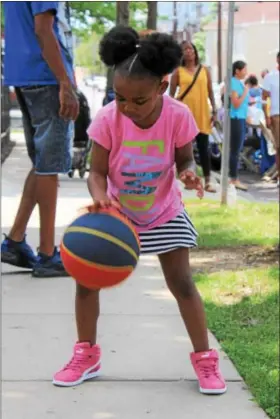  ?? MICHILEA PATTERSON — DIGITAL FIRST MEDIA ?? Trinity Key, 6, bounces a basketball during the 2nd Annual Pottstown Community Field Day at Chestnut Street Park on Saturday. Basketball dribbling was one of several fitness stations available during the event.