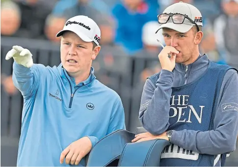  ??  ?? POINTING THE WAY: Scotland’s Robert Macintyre and his caddie during his first Open, which took place at Portrush.