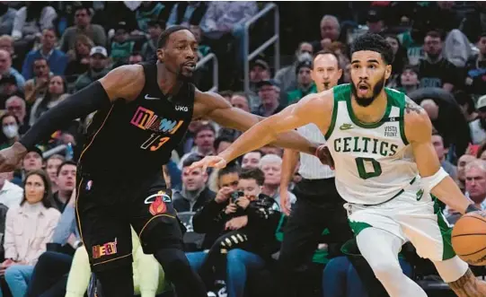  ?? CHARLES KRUPA/AP ?? The Celtics’ Jayson Tatum drives to the basket against the Heat’s Bam Adebayo on March 30 in Boston.