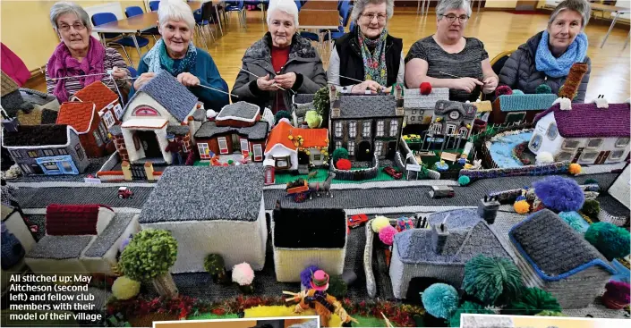  ??  ?? All stitched up: May Aitcheson (second left) and fellow club members with their model of their village