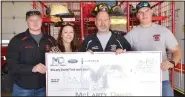  ?? (NWA Democrat-Gazette/Annette Beard) ?? Jessica Hudson, customer relations with McLarty Daniel, presented a check for $1,700 to Fire Chief Jack Wassman on Monday. Firefighte­rs Clayton Bass (left) and Quinn Gehler (right) joined in receiving the check presentati­on.