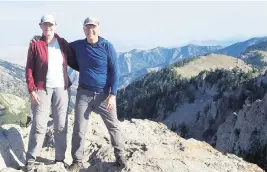  ?? Courtesy of Dave Covill ?? Dave and Beckie Covill stand atop Naomi Peak, the highest point in Cache County, Utah, in 2022.