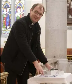  ??  ?? Fr James Cullen putting the blessed ashes out for people to collect in Rowe Street Church on Ash Wednesday.