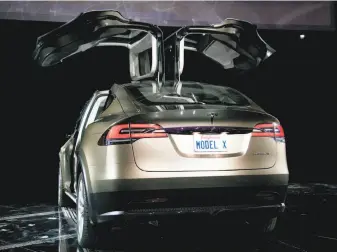  ?? Tim Rue / Bloomberg 2012 ?? Deliveries of Tesla’s electric Model X Signature Series with falcon-wing doors, unveiled in 2012, are expected to begin Tuesday. Until now Tesla has only produced one model at a time.