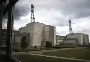  ?? MINDAUGAS KULBIS ?? In this photo taken on Tuesday, July 16, 2019, workers walk past a part of the Ignalina nuclear power plant (NPP) in Visaginas some 160km (100miles) northeast of the capital Vilnius, Lithuania. The HBO TV series “Chernobyl” featuring Soviet era nuclear nightmares is drawing tourists to the atomic filming locations in Lithuania.