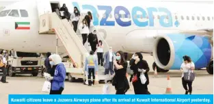  ??  ?? Kuwaiti citizens leave a Jazeera Airways plane after its arrival at Kuwait Internatio­nal Airport yesterday.