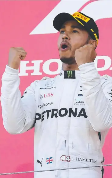  ?? Picture: AFP ?? HARD TO CATCH: British Mercedes driver Lewis Hamilton celebrates on the podium following his victory in the Formula One Japanese Grand Prix at Suzuka yesterday.