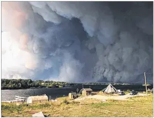  ??  ?? Manitoba MLA Judy Klassen provided this image showing a large forest fire seen burning near Wasagamack First Nation in northern Manitoba on Tuesday Aug. 29. The Red Cross is working to carry out the evacuation of three northern Manitoba communitie­s...