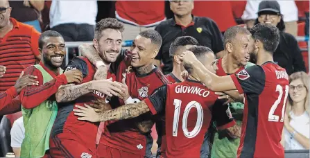  ?? COLE BURSTON THE CANADIAN PRESS ?? TFC midfielder Jay Chapman, second from left, celebrates his goal with some of his teammates during the second half of Major League Soccer action against the Los Angeles Galaxy at BMO Field in Toronto on Saturday. Toronto FC won the game 5-3, keeping their playoff hopes alive.