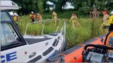  ?? ?? Carrybridg­e RNLI, the PSNI and NIFRS members working together to rescue the stranded cow. Photo: Police Fermanagh and Omagh Facebook page.