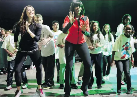  ?? GETTY IMAGES ?? Firmer first lady Michelle Obama dances with schoolchil­dren during an exercise program in 2013. Time after time, studies have pointed to the positive relationsh­ip between regular exercise and learning — for both children and adults.