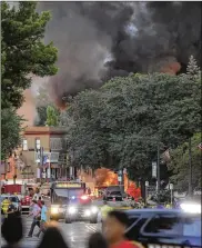  ?? AMBER ARNOLD/WISCONSIN STATE JOURNAL ?? Smoke rises as firefighte­rs work the scene of an explosion in downtown Sun Prairie, Wis., on Tuesday. A firefighte­r was killed in the blast.