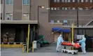  ??  ?? Workers wheel a body from the Wyckoff Heights medical center during the coronaviru­s outbreak in New York. Trump has told governors to find life-saving equipment on their own. Photograph: Andrew Kelly/ Reuters