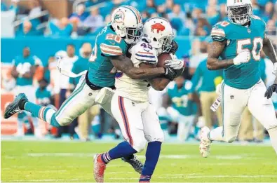  ?? MIKE EHRMANN/GETTY IMAGES ?? Reshad Jones, here making a tackle on Sunday against Buffalo, says he believes this is a playoff team, but that they just didn’t get it done. “We didn’t do what we set out to do,” he said.