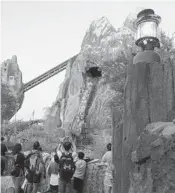  ?? DEWAYNE BEVIL/STAFF ?? Visitors to Disney’s Animal Kingdom theme park take an early evening ride on the Expedition Everest roller coaster. The park opened 20 years ago as Disney’s fourth park on the property.