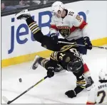  ?? MICHAEL DWYER — THE ASSOCIATED PRESS ?? Florida’s Anton Lundell, rear, and Boston’s Jesper Boqvist battle for the puck on Saturday in Boston.