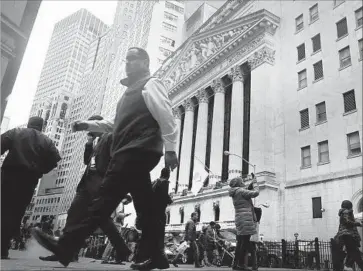  ?? Spencer Platt Getty Images ?? SMALLER FIRMS fared better than the rest of the market and more stocks rose than fell Thursday, signaling that investors are still confident in the U.S. economy. Above, outside the New York Stock Exchange.