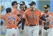  ?? AP PHOTO ?? NO PROBLEM, HOUSTON: Jose Altuve (27) and George Springer (4) celebrate the Astros’ series-clinching win against the Indians yesterday in Cleveland.