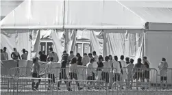  ?? WILFREDO LEE/AP ?? Children line up to enter a tent at the Homestead Temporary Shelter for Unaccompan­ied Children in Homestead, Fla., in February 2019.