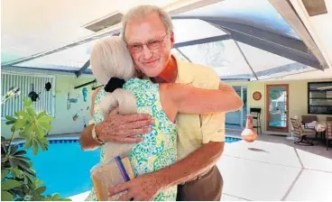  ?? CARLINE JEAN/SUN SENTINEL PHOTOS ?? Retired Marine Robert D. Wells, 74, of Delray Beach, hugs Monique Bourassa Fuchs, of Lighthouse Point.