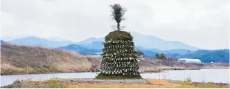  ?? Courtesy of the artist and Johyun Gallery ?? Artist Lee Bae’s “daljip,” or moon house, is staged in his hometown of Cheongdo County, North Gyeongsang Province, Feb. 24. The event draws inspiratio­n from a Korean folk tradition that involves igniting a giant wooden pyre on the day of the first full moon of the lunar new year to ward off evil spirits.