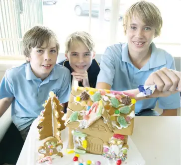  ??  ?? Above: Hard at work creating a gingerbrea­d house at Warragul Salvation Army are (from left) brothers Jacob, Rylan and Ethan Bongiorno.