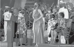  ?? JEFF J MITCHELL/PA ?? Prime Minister Mia Mottley, left, and President Sandra Mason, right, honor singer Rihanna on Tuesday after the island nation of Barbados became a republic.