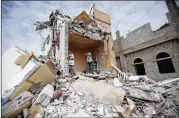  ?? HANI MOHAMMED / ASSOCIATED PRESS 2017 ?? Boys stand on rubble of a house hit by Saudi-led airstrikes in Sanaa, Yemen, in 2017. Yemen’s stalemated, three-year war has killed over 10,000.