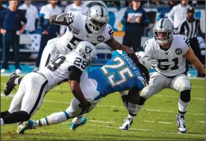  ?? BRIAN VAN DER BRUG/TRIBUNE NEWS SERVICE ?? Chargers running back Melvin Gordon (25) is brought down by Raiders free safety Lamarcus Joyner (29) on Sunday in Carson.