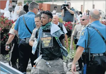  ?? Picture: AFP ?? Police arrest a demonstrat­or yesterday protesting the shooting death of Michael Brown in Ferguson, Missouri. Protesters have been vocal asking for justice in the shooting death of the teenager by a Ferguson police officer on August 9th.