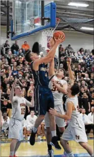  ?? AUSTIN HERTZOG - DIGITAL FIRST MEDIA ?? Spring-Ford’s Austin Hokanson goes up for a layup while Perkiomen Valley’s Hogan Millheim defends.