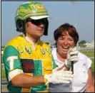  ?? RICH SCHULTZ — THE ASSOCIATED PRESS ?? Driver Tim Tetrick, left, and trainer Linda Toscano celebrate after their horse Market Share won the Hambletoni­an trotting race at Meadowland­s Race
Track in East Rutherford, N. J., in August 2012.