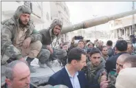  ?? AP PHOTO ?? In this photo released on the official Facebook page of the Syrian Presidency, Syrian President Bashar Assad, centre, speaks with Syrian troops during his visit to the front line in the newly captured areas of eastern Ghouta, near the capital Damascus, Syria, Sunday.