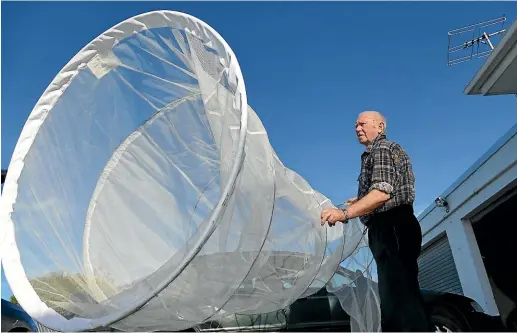  ?? JOHN HAWKINS/STUFF ?? Bruce Lawson checks his whitebait net in preparatio­n for the season, which opens on August 15.