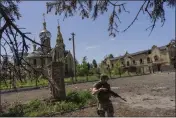 ?? BERNAT ARMANGUE — THE ASSOCIATED PRESS ?? A Ukrainian serviceman patrols a village near the frontline in eastern Ukraine on Thursday.