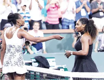  ?? — AFP photo ?? Venus Williams (L) of United States hug Serena Williams after her win over her sister during Day 8 of BNP Paribas Open on March 12, 2018 in Indian Wells, California.