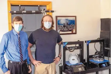  ?? CAMERON GOELDNER/VALENCIA COUNTY NEWS-BULLETIN ?? Chris Williford, left, and Sean Storms, right, stand next to Turtle Rocket’s 3-D printers, located in Storms’ home in Bosque Farms. The two started the company in January and make miniatures for games such as Dungeons and Dragons, as well as anything else that can be produced within the size restraints of the machine.