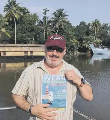  ??  ?? John Pleavin with the Wear On Board poster in India.