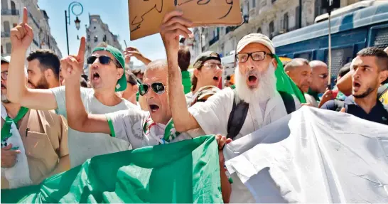  ?? AFP ?? Protesters chant slogans against the ruling elite in Algiers amid an ongoing political crisis in Algeria on the 26th consecutiv­e Friday of demonstrat­ions. The movement has already seen the resignatio­n of the country’s president and the detention of numerous officials.