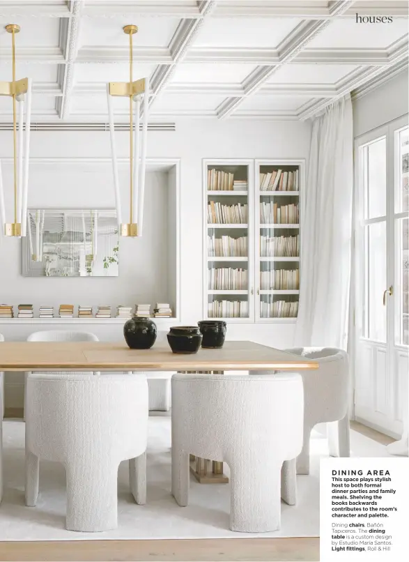  ??  ?? DINING AREA
This space plays stylish host to both formal dinner parties and family meals. Shelving the books backwards contribute­s to the room’s character and palette.
Dining chairs, Bañón Tapiceros. The dining table is a custom design by Estudio María Santos. Light fittings, Roll & Hill