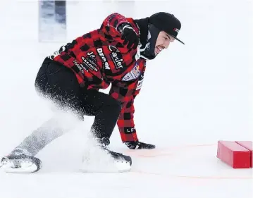  ??  ?? Red Bull Crashed Ice competitor Steven Cox makes the snow fly during the event.