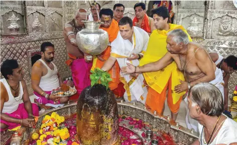  ??  ?? Congress president Rahul Gandhi with party leaders Kamal Nath and Jyotiradit­ya Scindia offering prayers at Mahakalesh­war temple in Ujjain