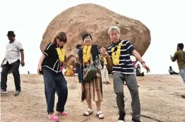  ?? — PTI ?? Chinese tourists visit ‘Krishna’s Butterball’ in the heritage site area near the Shore Temple in Mamallapur­am on Thursday.