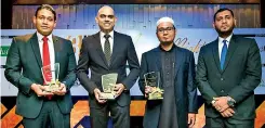  ??  ?? Business Channels DGM Prasanna Karadagoll­a holding the award for the ‘Window of the Year’, Director and CEO Krishan Thilakarat­na holding the award for the ‘Islamic Finance Entity of the Year’, Zaid Nooramith holding the award for the ‘Leasing Company of the Year’ and Ilsam Awfer at the IFFSA Award 2018