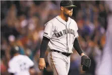  ?? David Zalubowski / Associated Press ?? Giants reliever Hunter Strickland walks off the mound after giving up the game-winning hit to Chris Iannetta in the 10th.