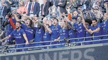  ?? REUTERS ?? Chelsea’s Gary Cahill lifts the trophy as they celebrate winning the FA Cup final.