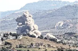  ?? RABIH DAHER AFP via Getty Images/TNS ?? A smoke plume rises over the Lebanese village of Kfar Kila during Israeli bombardmen­t on Thursday amid cross-border clashes between Israeli and Hezbollah fighters.